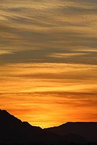 Scenic view of silhouette mountains against sky during sunset