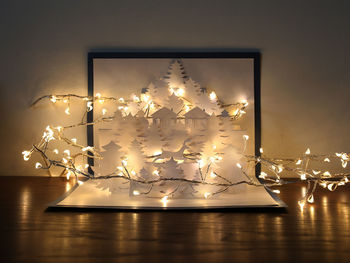 Close-up of illuminated lighting equipment on table at home