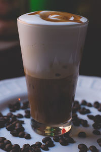 Close-up of cappuccino in glass on table