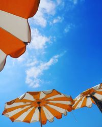 Low angle view of umbrellas against sky
