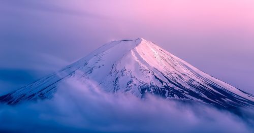 Aerial view of snowcapped mountain against sky during winter