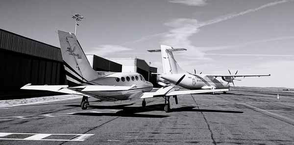 Airplane at airport against sky