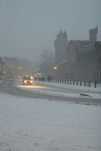 Cars on street in city during winter