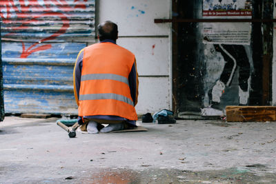 Rear view of man working on street