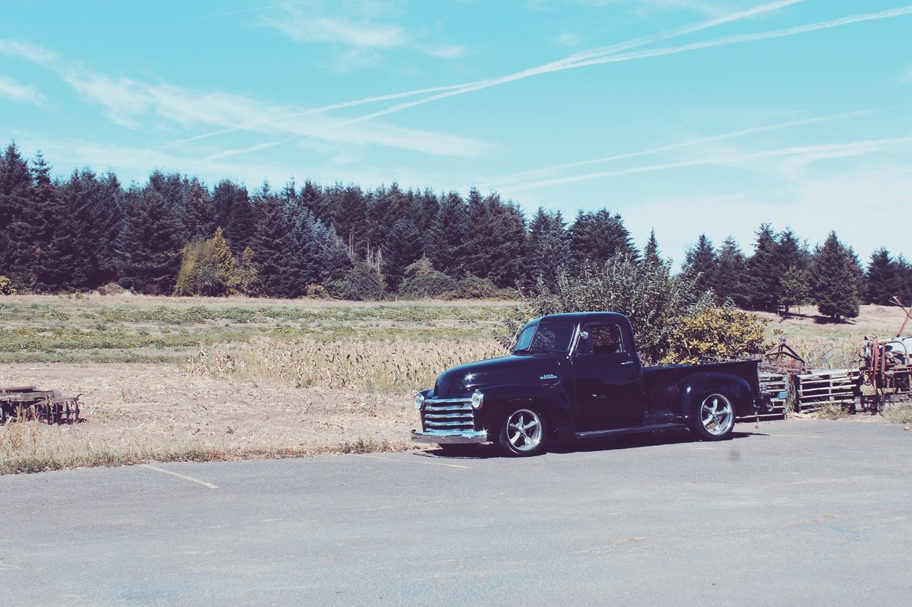 transportation, mode of transport, land vehicle, tree, car, landscape, stationary, parking, dirt road, street, sky, blue, outdoors, parked, sunny, day, vapor trail, vehicle, non-urban scene, tranquil scene, rural scene, no people, scenics