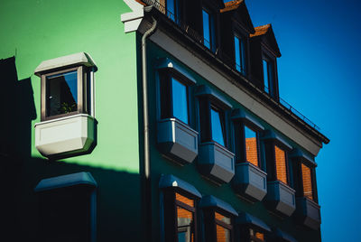 Low angle view of illuminated building against blue sky