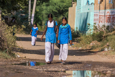 Rear view of two people running