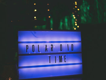 Information sign against wall at night