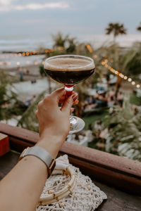 Cropped hand of woman holding wineglass