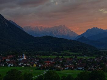 Scenic view of houses and mountains against sky