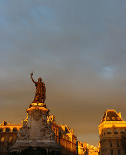 Low angle view of statue against cloudy sky