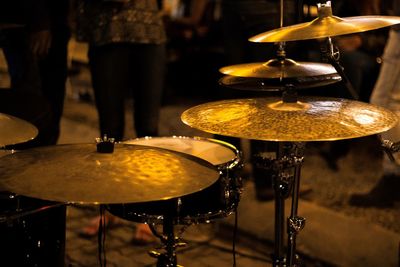 Close-up of drum kit on footpath at night