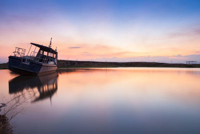 Scenic view of lake against sky during sunset