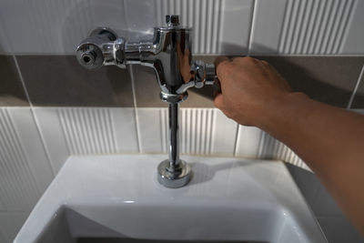 Cropped hand opening faucet