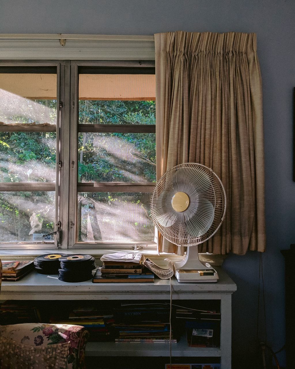 window, indoors, table, no people, home interior, day, transparent, fan, glass - material, furniture, electric fan, curtain, hanging, wood - material, still life, water, nature, technology, electric lamp, ceiling