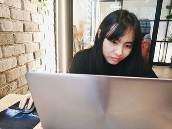 Portrait of young woman using mobile phone