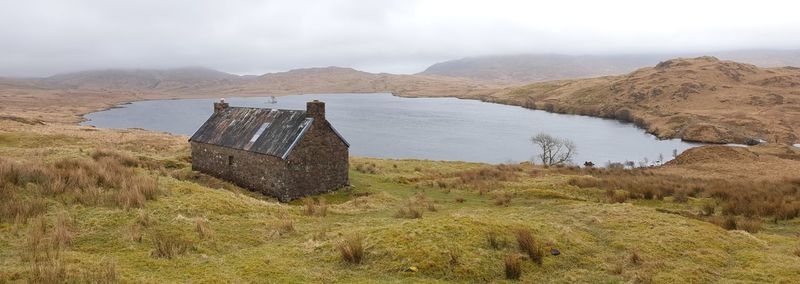 Scenic view of landscape against sky bothy by the loch
