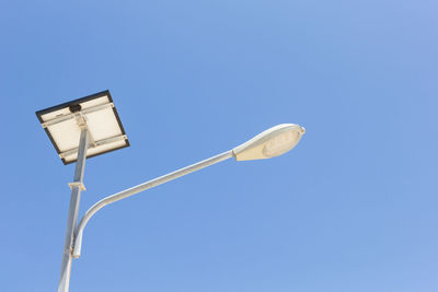 Low angle view of street light against clear blue sky