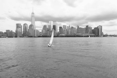 View of buildings in city against cloudy sky