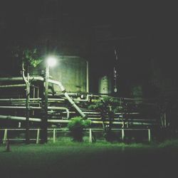 Illuminated street lights on field at night