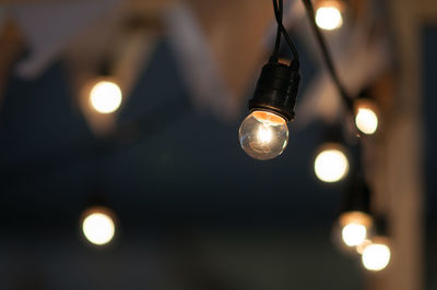 Close-up of fairy lights against blurred background