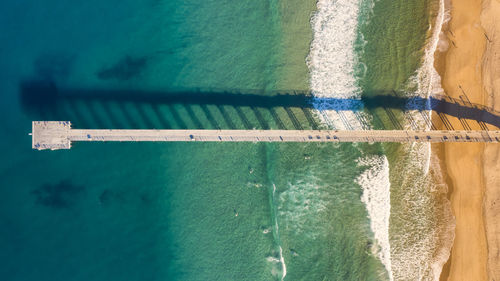 Aerial view of pier at beach over sea