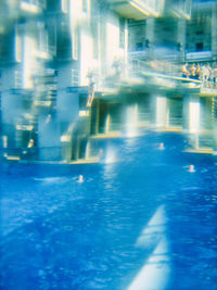 Reflection of people in swimming pool