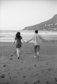 Rear view of couple on beach