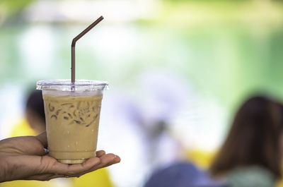 Close-up of hand holding drink
