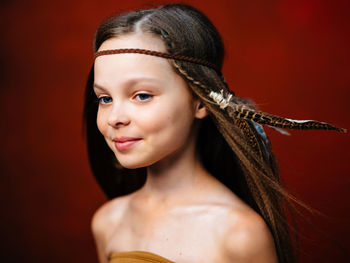 Smiling teenager girl against colored background