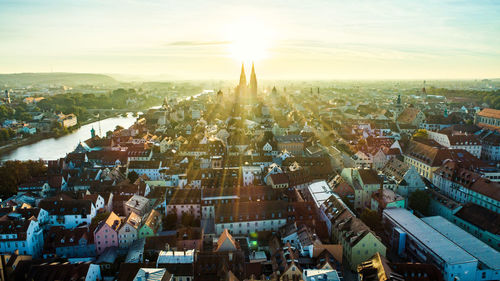 High angle view of city buildings against sky during sunset