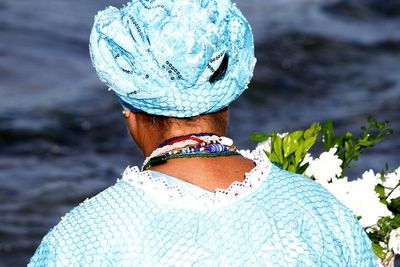 Rear view of woman standing against sea