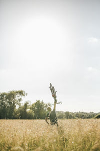 Young man lifting up his bike