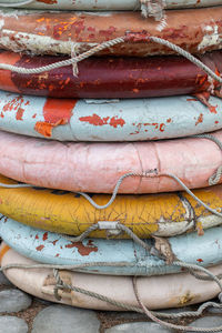 Close up of old weathered lifebuoys awaiting restoration and painting. vertical shot.