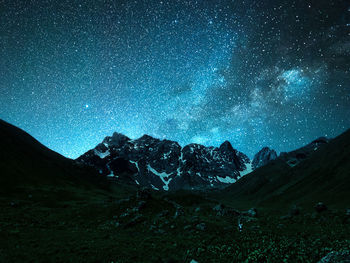 Scenic view of mountains against sky at night