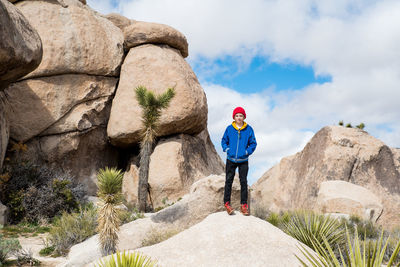 Tween standing on stones in joshua tree national park