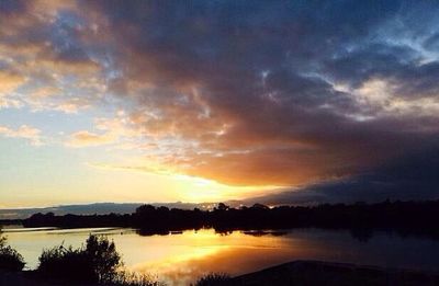 Scenic view of lake at sunset