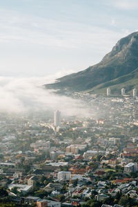 High angle view of cityscape against cloudy sky