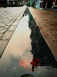 Street reflecting in puddle
