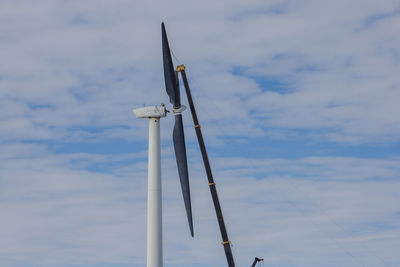 Low angle view of wind turbine against sky