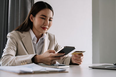 Businesswoman using laptop at office