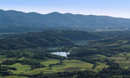 Scenic view of lake and mountains against clear sky