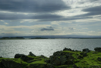 Scenic view of sea against cloudy sky