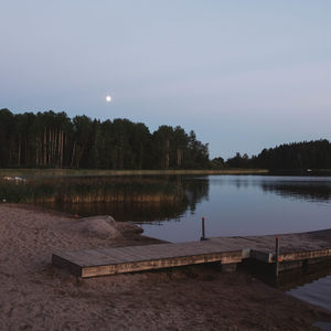 Scenic view of lake against sky at night