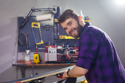 Portrait of smiling man working in workshop