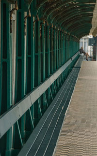 Very long green wooden bench