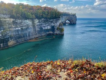 Scenic view of sea and cliffs against sky