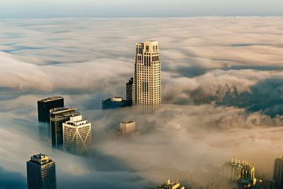 Low angle view of skyscrapers against sky during sunset