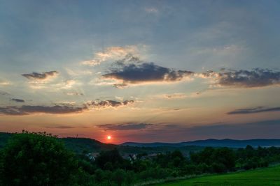 Scenic view of landscape against sky at sunset
