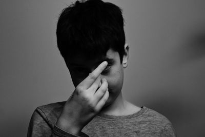 Close-up of boy against wall